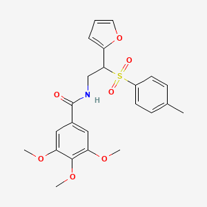 molecular formula C23H25NO7S B11251697 N-[2-(furan-2-yl)-2-(4-methylbenzenesulfonyl)ethyl]-3,4,5-trimethoxybenzamide 
