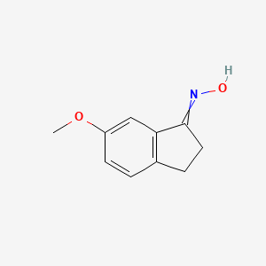B1143108 (E)-6-methoxy-2,3-dihydro-1H-inden-1-one oxime CAS No. 180915-76-8