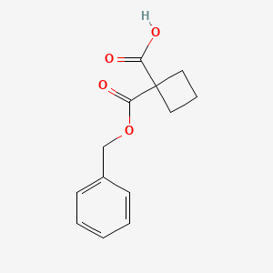 molecular formula C13H14O4 B12069986 Cyclobutane-1,1-dicarboxylic acid benzyl ester 