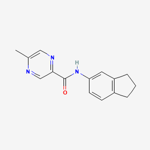molecular formula C15H15N3O B1224332 N-(2,3-dihydro-1H-inden-5-yl)-5-methylpyrazine-2-carboxamide 