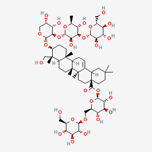 molecular formula C59H96O27 B1231834 [(2S,3R,4S,5S,6R)-3,4,5-trihydroxy-6-[[(2S,3R,4S,5S,6R)-3,4,5-trihydroxy-6-(hydroxymethyl)oxan-2-yl]oxymethyl]oxan-2-yl] (4aS,6aS,6bR,9R,10S,12aR)-10-[(2S,3R,4S,5S)-3-[(2S,3R,4R,5S,6S)-3,5-dihydroxy-6-methyl-4-[(2S,3R,4S,5S,6R)-3,4,5-trihydroxy-6-(hydroxymethyl)oxan-2-yl]oxyoxan-2-yl]oxy-4,5-dihydroxyoxan-2-yl]oxy-9-(hydroxymethyl)-2,2,6a,6b,9,12a-hexamethyl-1,3,4,5,6,6a,7,8,8a,10,11,12,13,14b-tetradecahydropicene-4a-carboxylate 