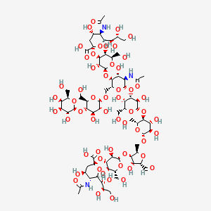 molecular formula C72H117N3O56 B1246369 N-acetyl-alpha-neuraminyl-(2->3)-beta-D-galactosyl-(1->4)-[N-acetyl-alpha-neuraminyl-(2->3)-beta-D-galactosyl-(1->4)-[beta-D-galactosyl-(1->4)-beta-D-glucosyl-(1->6)]-N-acetyl-beta-D-glucosaminyl-(1->3)-beta-D-galactosyl-(1->4)-beta-D-glucosyl-(1->6)]-2,5-anhydro-D-mannose 