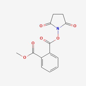 molecular formula C13H11NO6 B1249353 Methyl 2-[(succinimidooxy)carbonyl]benzoate CAS No. 438470-19-0