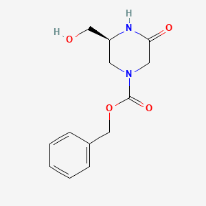 molecular formula C13H16N2O4 B12991498 Benzyl (S)-3-(hydroxymethyl)-5-oxopiperazine-1-carboxylate 