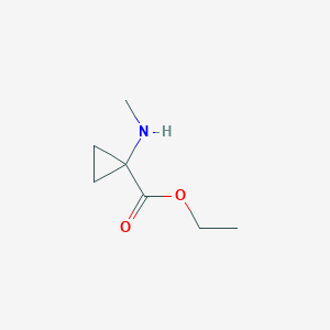 molecular formula C7H13NO2 B13204261 Ethyl 1-(methylamino)cyclopropanecarboxylate 