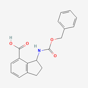 molecular formula C18H17NO4 B13207414 3-{[(benzyloxy)carbonyl]amino}-2,3-dihydro-1H-indene-4-carboxylic acid 