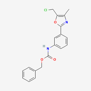 molecular formula C19H17ClN2O3 B13208114 Benzyl N-{3-[5-(chloromethyl)-4-methyl-1,3-oxazol-2-yl]phenyl}carbamate 