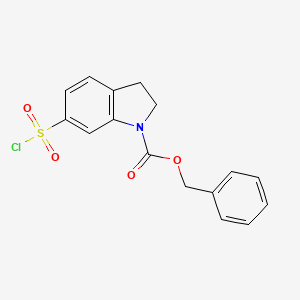 molecular formula C16H14ClNO4S B13217158 Benzyl 6-(chlorosulfonyl)-2,3-dihydro-1H-indole-1-carboxylate 