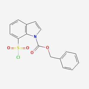 molecular formula C16H12ClNO4S B13218008 Benzyl 7-(chlorosulfonyl)-1H-indole-1-carboxylate 