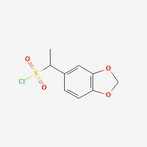 molecular formula C9H9ClO4S B13228682 1-(1,3-Dioxaindan-5-yl)ethane-1-sulfonyl chloride 