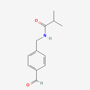 molecular formula C12H15NO2 B13258180 N-[(4-Formylphenyl)methyl]-2-methylpropanamide 