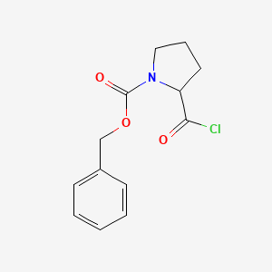 molecular formula C13H14ClNO3 B1336272 1-吡咯烷羧酸，2-(氯羰基)-，苯甲酯 CAS No. 61350-62-7