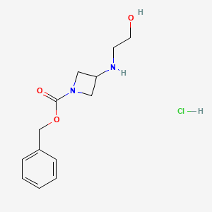molecular formula C13H19ClN2O3 B13451190 Benzyl 3-[(2-hydroxyethyl)amino]azetidine-1-carboxylate hydrochloride 