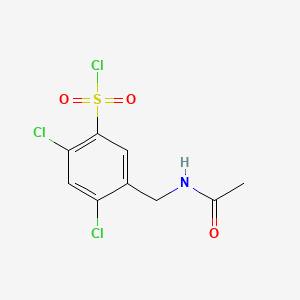 molecular formula C9H8Cl3NO3S B13486077 2,4-Dichloro-5-(acetamidomethyl)benzene-1-sulfonyl chloride 