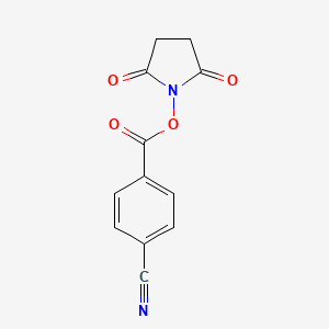 molecular formula C12H8N2O4 B1353566 Benzonitrile, 4-[[(2,5-dioxo-1-pyrrolidinyl)oxy]carbonyl]- CAS No. 99300-38-6