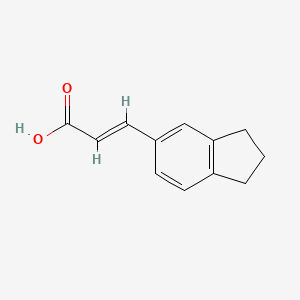 B1353737 5-Indanacrylic acid CAS No. 56635-88-2