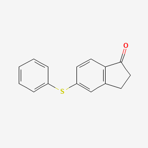 molecular formula C15H12OS B1367115 5-Phenylsulfanyl-indan-1-one 