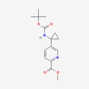 molecular formula C15H20N2O4 B13685748 Methyl 5-[1-(Boc-amino)cyclopropyl]picolinate 