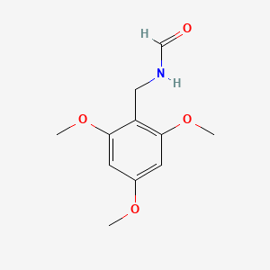 molecular formula C11H15NO4 B13686458 N-(2,4,6-Trimethoxybenzyl)formamide 