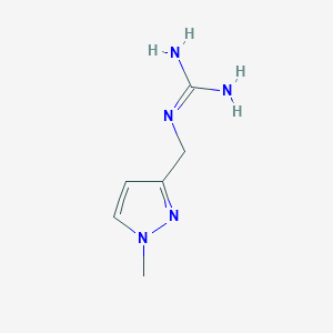molecular formula C6H11N5 B13686982 1-[(1-Methyl-3-pyrazolyl)methyl]guanidine 