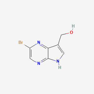 molecular formula C7H6BrN3O B1374968 (2-bromo-5H-pyrrolo[2,3-b]pyrazin-7-yl)methanol CAS No. 1334674-88-2