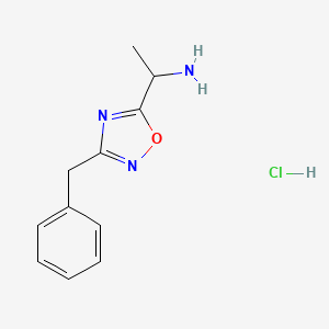 molecular formula C11H14ClN3O B1375842 1-(3-Benzyl-1,2,4-oxadiazol-5-yl)ethan-1-amine hydrochloride CAS No. 1384428-19-6