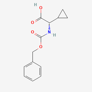 molecular formula C13H15NO4 B1376332 (S)-Benzyloxycarbonylamino-cyclopropyl-acetic acid CAS No. 269406-90-8