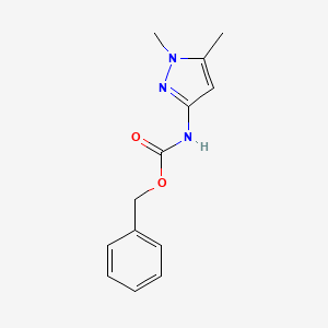molecular formula C13H15N3O2 B1378216 3-(Cbz-amino)-1,5-dimethylpyrazole CAS No. 1445322-58-6