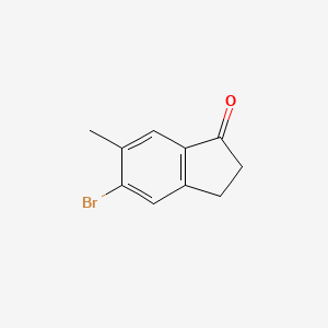 molecular formula C10H9BrO B1380560 5-Bromo-6-methyl-1-indanone CAS No. 1273655-83-6