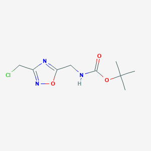 molecular formula C9H14ClN3O3 B1382228 tert-butyl N-{[3-(chloromethyl)-1,2,4-oxadiazol-5-yl]methyl}carbamate CAS No. 1803601-86-6