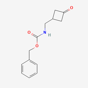 molecular formula C13H15NO3 B1383082 苯甲酸苄酯 n-[(3-氧代环丁基)甲基] CAS No. 1869903-79-6