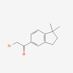 molecular formula C13H15BrO B13886083 2-Bromo-1-(1,1-dimethyl-2,3-dihydroinden-5-yl)ethanone 