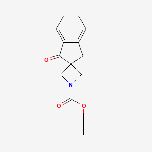molecular formula C16H19NO3 B13893738 Tert-butyl 1'-oxospiro[azetidine-3,2'-indane]-1-carboxylate 