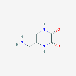 molecular formula C5H9N3O2 B1390252 5-(Aminomethyl)piperazine-2,3-dione CAS No. 1186467-04-8