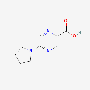 molecular formula C9H11N3O2 B1418854 5-(Pyrrolidin-1-yl)pyrazine-2-carboxylic acid CAS No. 1210030-17-3