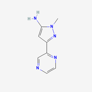 molecular formula C8H9N5 B1433743 1-methyl-3-(pyrazin-2-yl)-1H-pyrazol-5-amine CAS No. 1414568-74-3