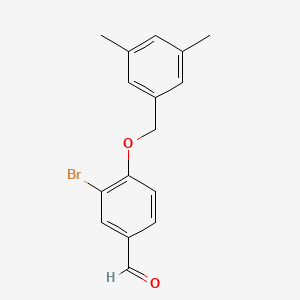 molecular formula C16H15BrO2 B1438991 3-Bromo-4-[(3,5-dimethylbenzyl)oxy]benzenecarbaldehyde CAS No. 1135283-80-5