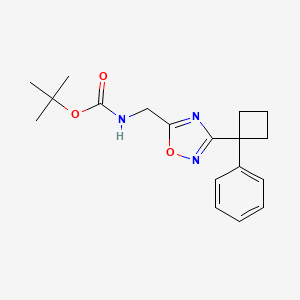 molecular formula C18H23N3O3 B1446331 [3-(1-Phenyl-cyclobutyl)-[1,2,4]oxadiazol-5-ylmethyl]-carbamic acid tert-butyl ester CAS No. 1858242-09-7