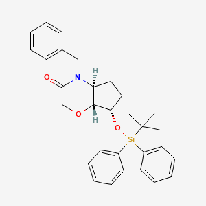 B1449378 Racemic-(4aS,7S,7aR)-4-benzyl-7-(tert-butyldiphenylsilyloxy)hexahydrocyclopenta[b][1,4]oxazin-3(2H)-one CAS No. 1422343-94-9