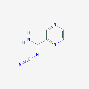 molecular formula C6H5N5 B1453349 Pyrazine-2-N-cyanoamidine CAS No. 1053656-81-7