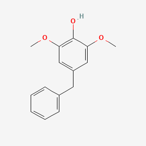 molecular formula C15H16O3 B14566398 Phenol, 2,6-dimethoxy-4-(phenylmethyl)- CAS No. 61563-90-4