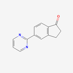 molecular formula C13H10N2O B1457074 5-Pyrimidin-2-yl-indan-1-one CAS No. 1334784-74-5
