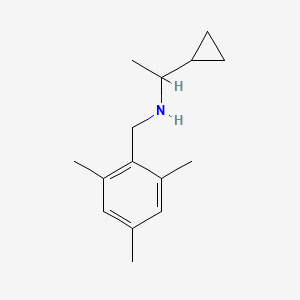 molecular formula C15H23N B1462656 (1-Cyclopropylethyl)[(2,4,6-trimethylphenyl)methyl]amine CAS No. 1155606-85-1