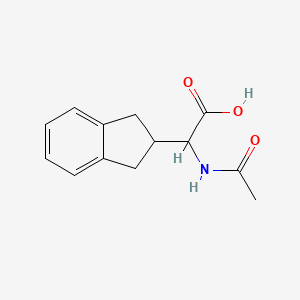 molecular formula C13H15NO3 B1464734 2-(2,3-dihydro-1H-inden-2-yl)-2-acetamidoacetic acid CAS No. 179186-26-6