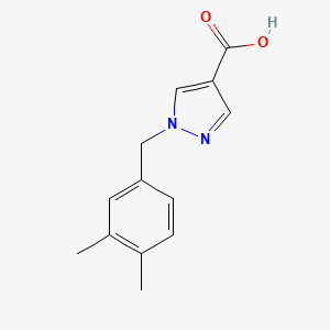molecular formula C13H14N2O2 B1465609 1-[(3,4-dimethylphenyl)methyl]-1H-pyrazole-4-carboxylic acid CAS No. 1271696-24-2