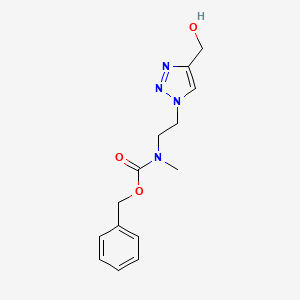 molecular formula C14H18N4O3 B1480616 benzyl (2-(4-(hydroxymethyl)-1H-1,2,3-triazol-1-yl)ethyl)(methyl)carbamate CAS No. 2097978-67-9