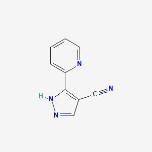 molecular formula C9H6N4 B1486362 3-(pyridin-2-yl)-1H-pyrazole-4-carbonitrile CAS No. 1216188-69-0