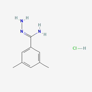 molecular formula C9H14ClN3 B1526161 N'-amino-3,5-dimethylbenzene-1-carboximidamide hydrochloride CAS No. 1354968-76-5