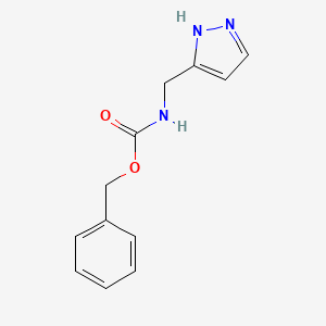 molecular formula C12H13N3O2 B1526498 benzyl N-(1H-pyrazol-3-ylmethyl)carbamate CAS No. 1291937-65-9