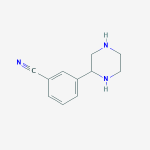 molecular formula C11H13N3 B1638510 3-Piperazin-2-ylbenzonitrile 